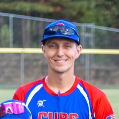 James, the youth sports coach who built SCOUT, in a team jersey and cap at a ballfield